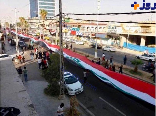 عکس/ پرچم 500متری عراق بردوش مردم کرکوک